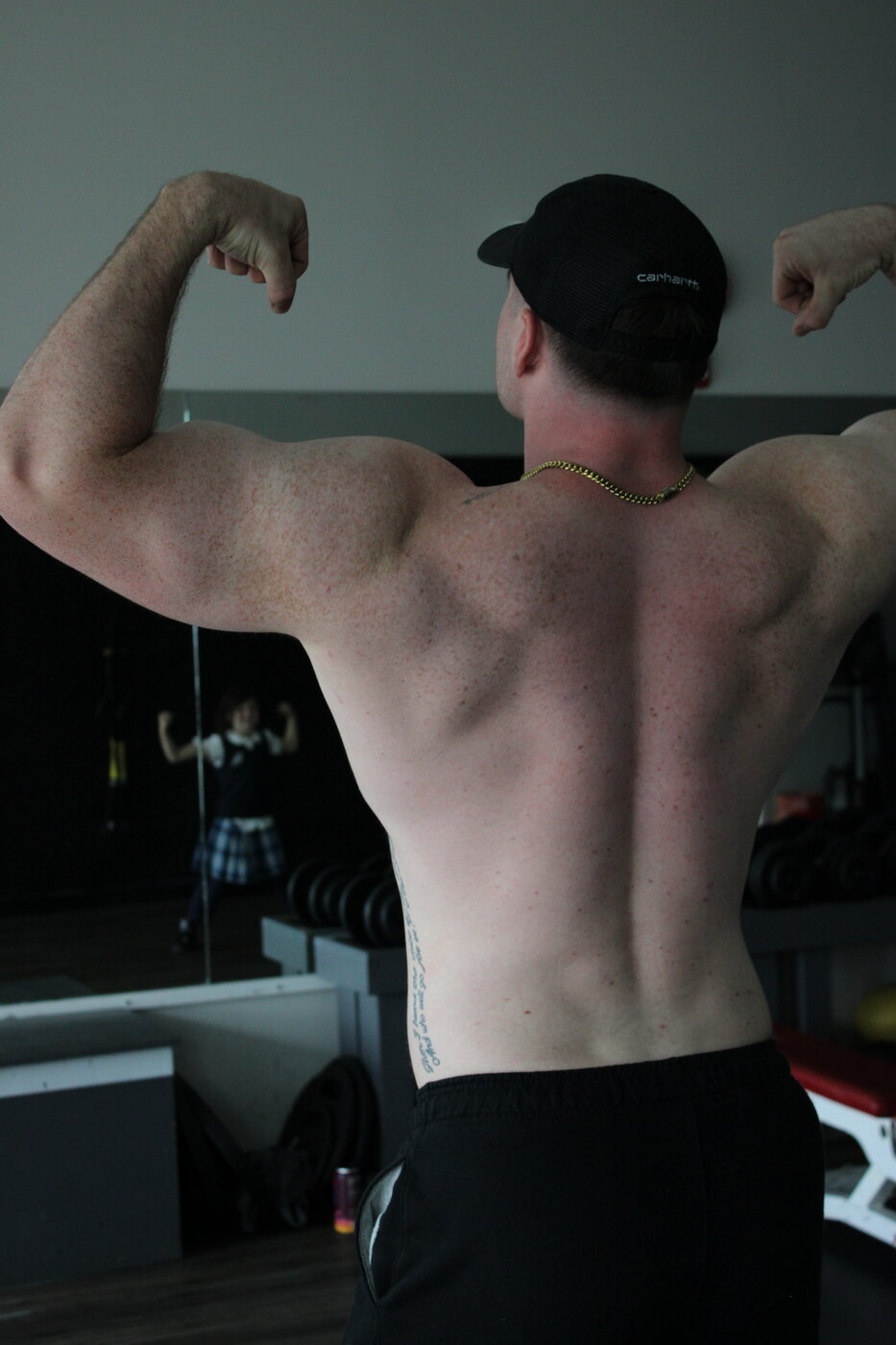 Back double biceps in a dark gym