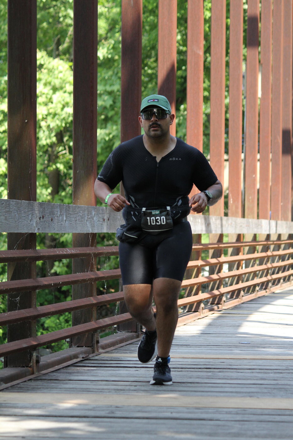 Runner crossing a bridge mid-race