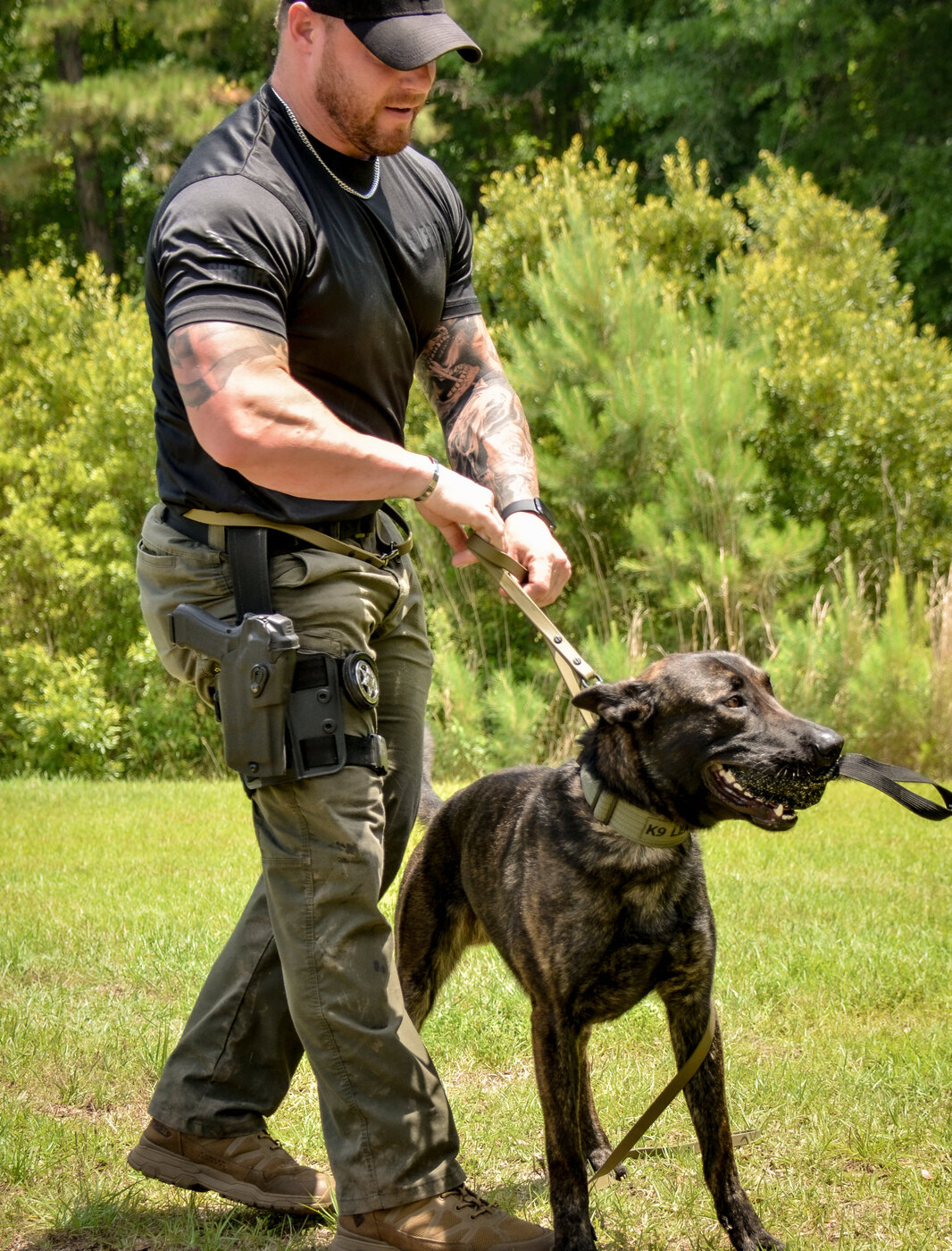 Handler with working dog in tactical kit